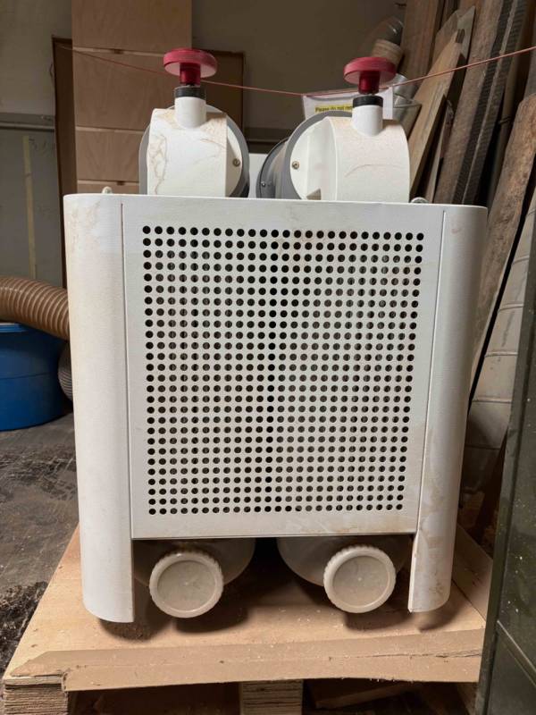 Two HEPA filters. Turn the red knobs on top to knock dust loose. The white caps on the bottom are the collection ports. Two HEPA filters. Turn the red knobs on top to knock dust loose. The white caps on the bottom are the collection ports.